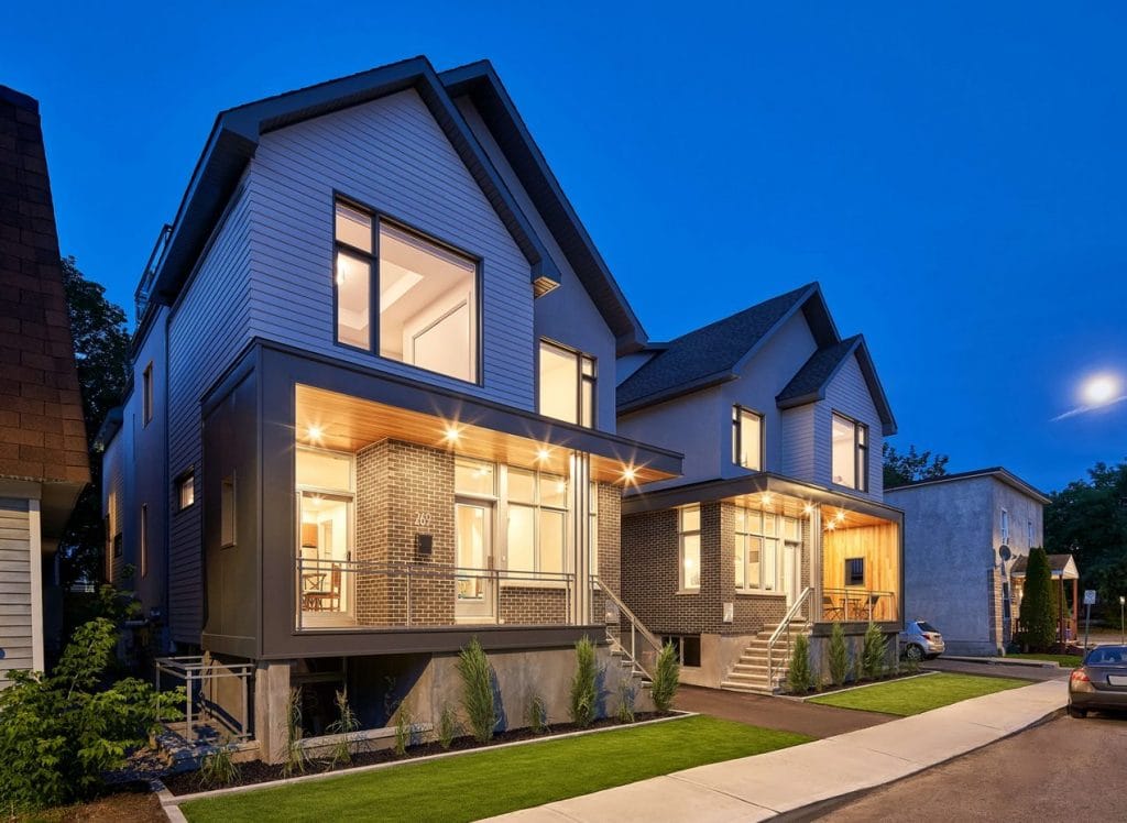 photo at dusk of the exterior of two four-unit homes in Hintonburg.