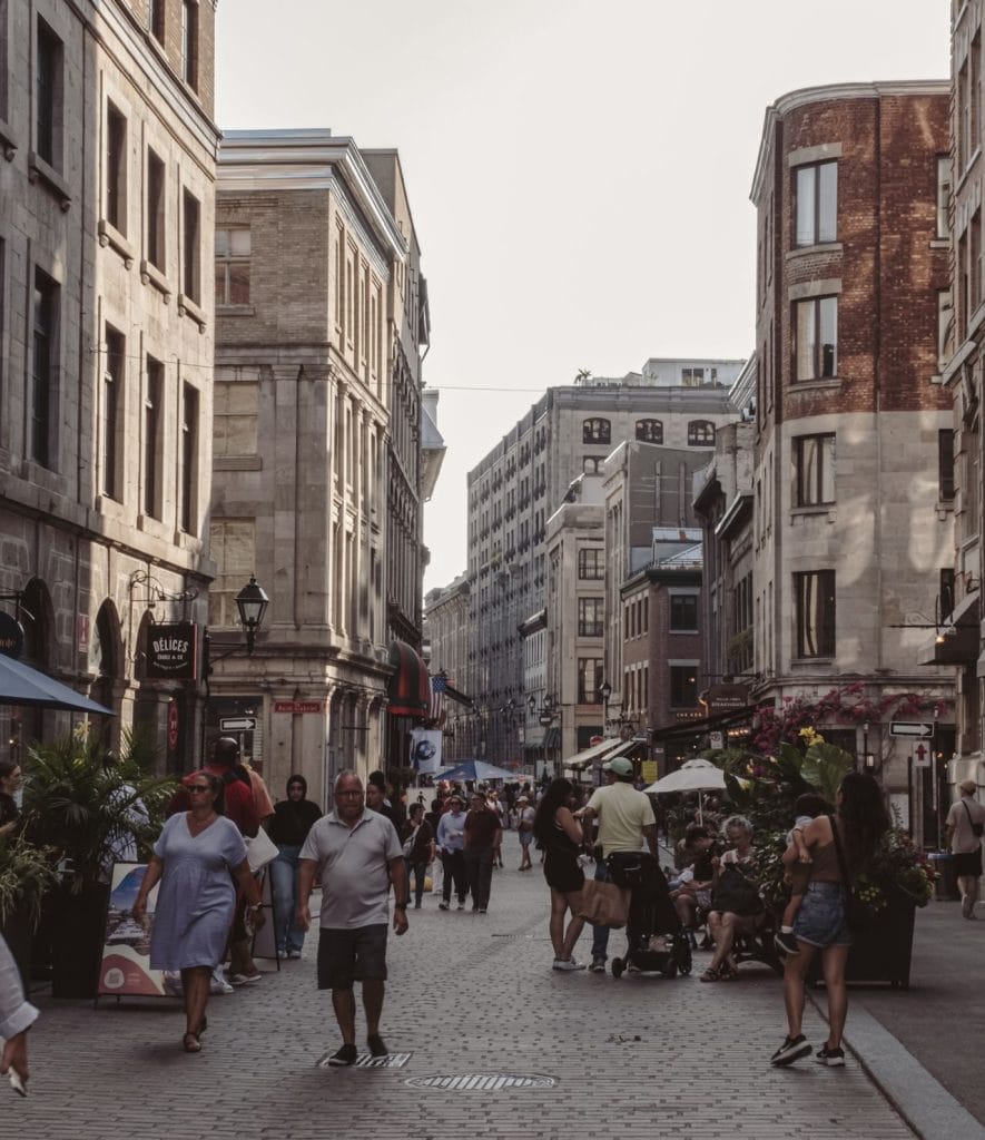 pedestrians walk on a street in Old Montreal