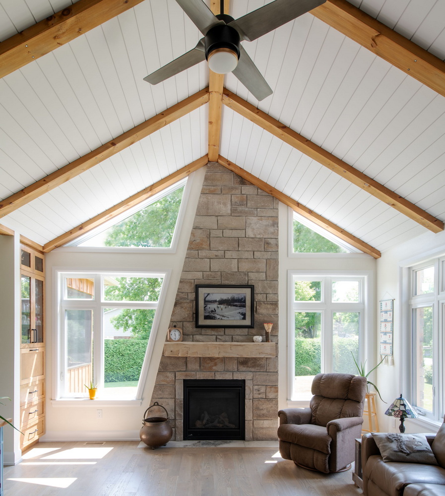 Cathedral ceiling beams asymmetrical stone living room Corvinelli Homes