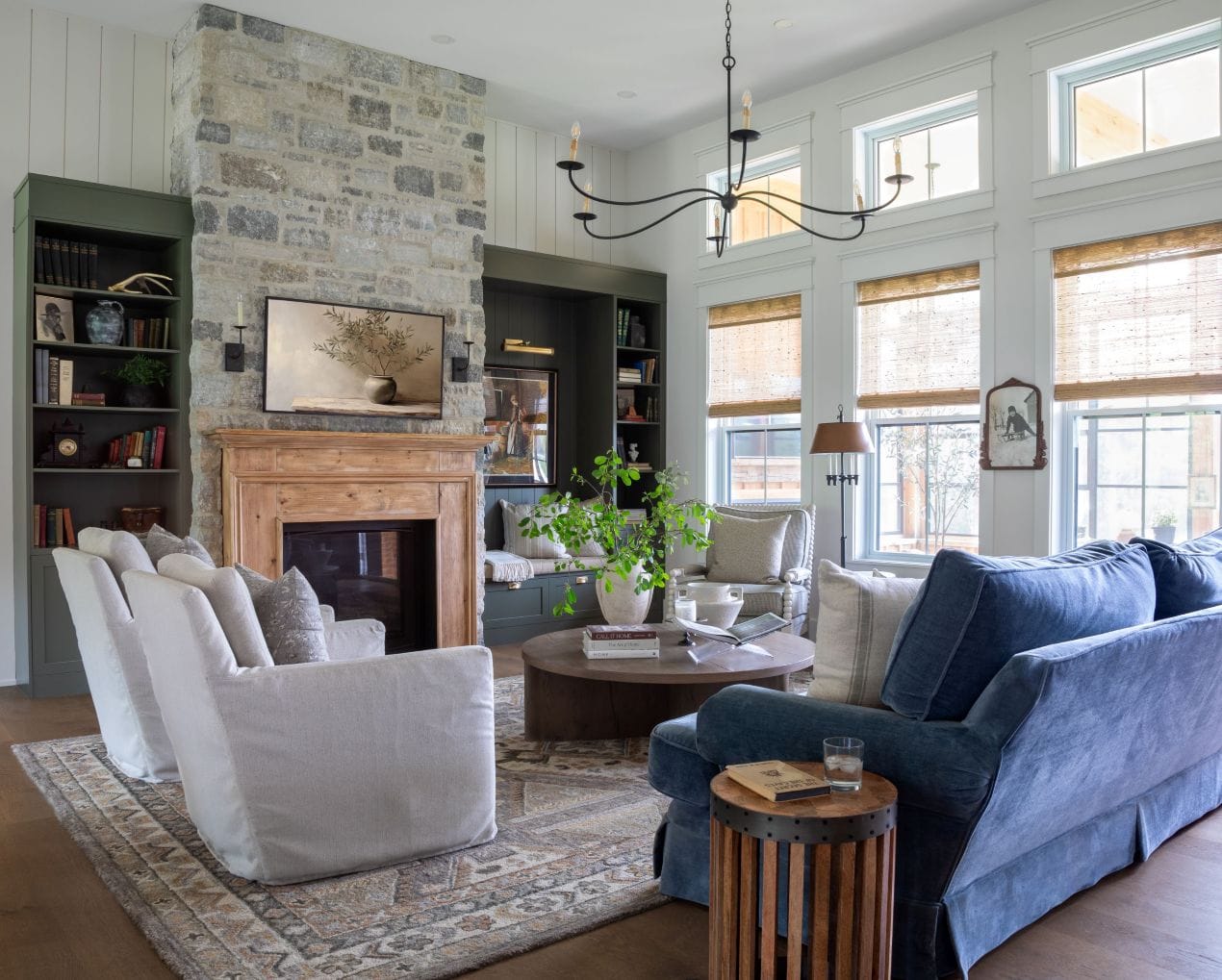 Photo of the living room with its custom-made mantlepiece and stone fireplace.