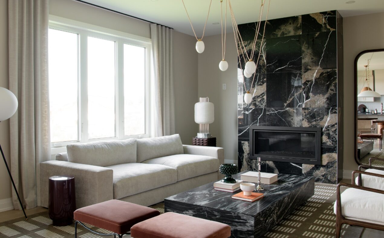 Photo of the living room with its dramatic fireplace surround in Minto's Mackenzie model home in Mahogany.