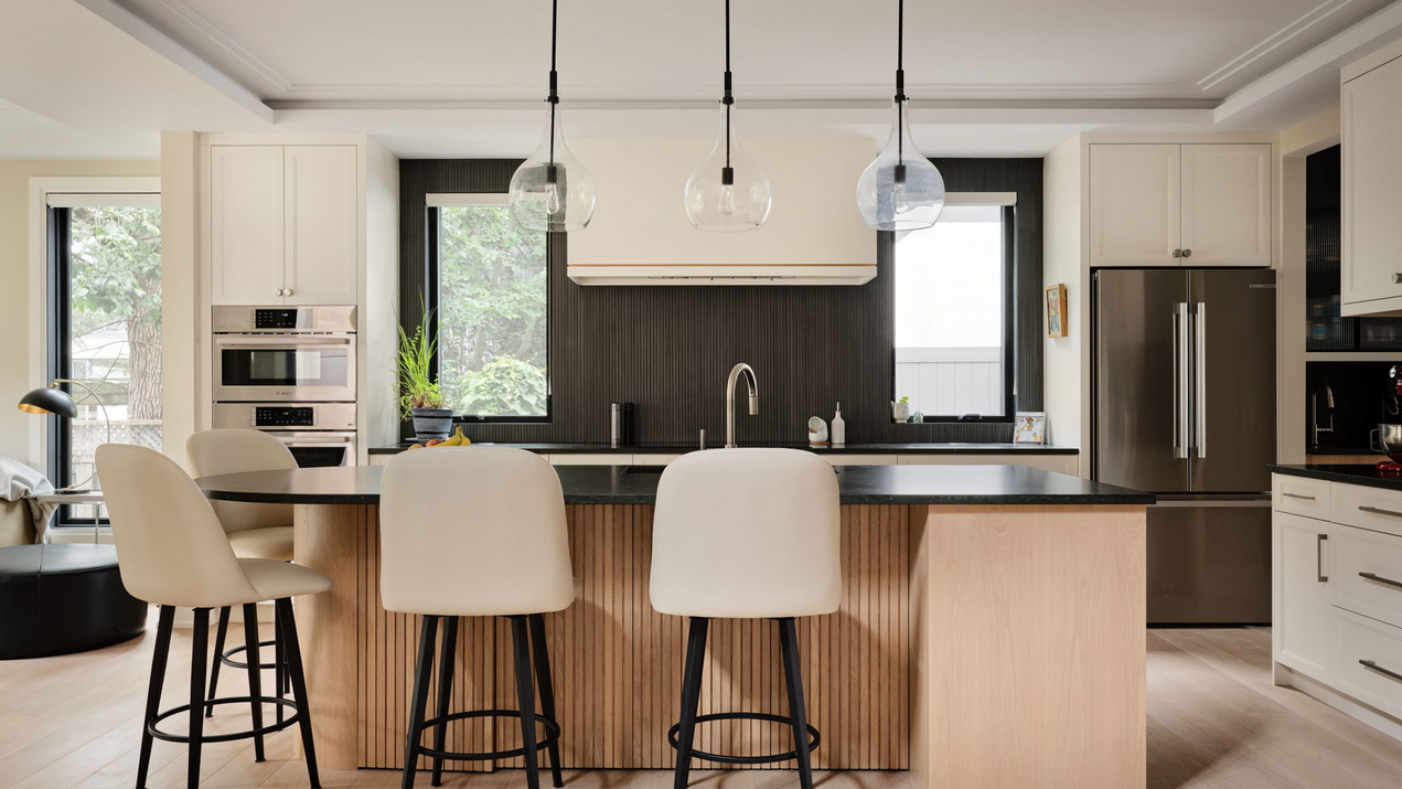 Ottawa kitchen by Amsted Design-Build with a mix of white and wood cabinets and an island with seating
