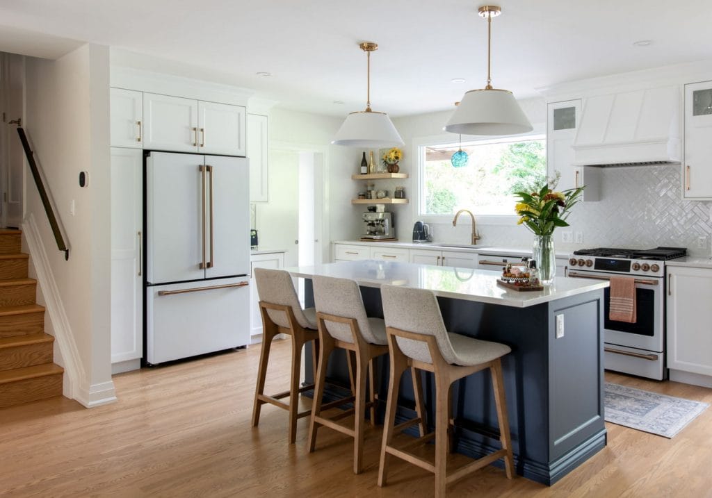 traditional kitchen with white perimeter cabinets and a blue island