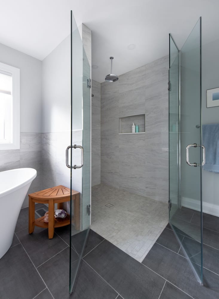 bathroom with corner shower featuring glass doors
