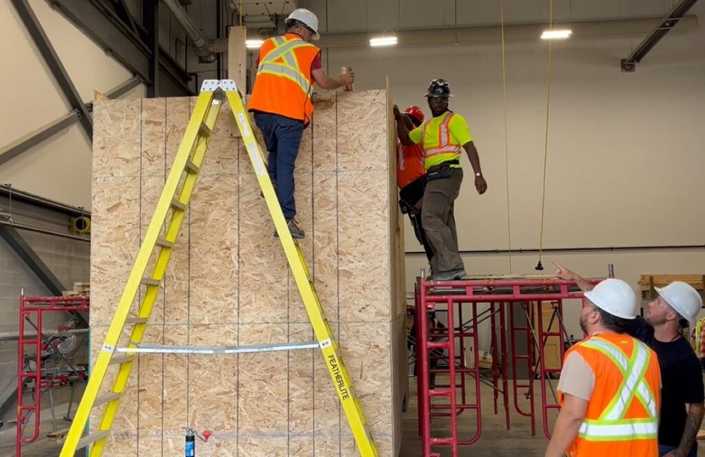 Photo of Students working on a tiny home under the direction of supervisors at College la Cite