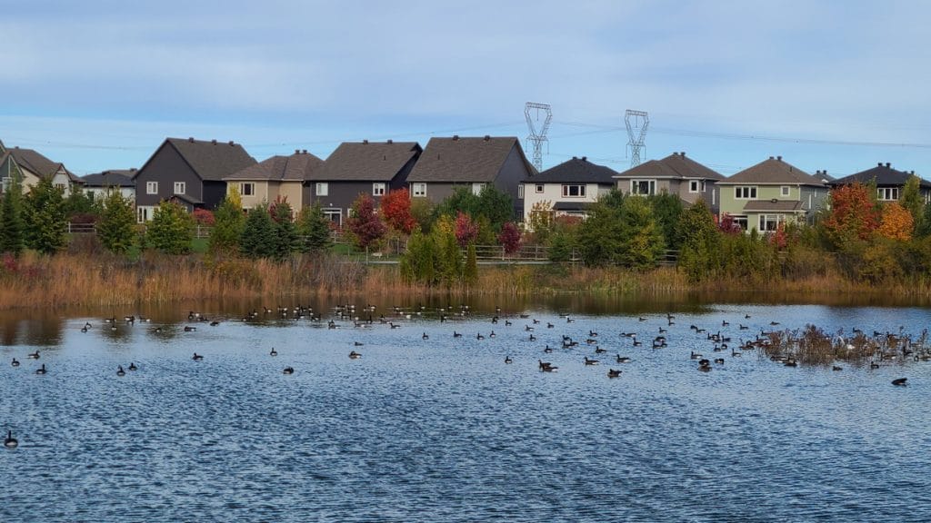 A housing subdivision is seen behind a stormwater management pond in Ottawa’s west end