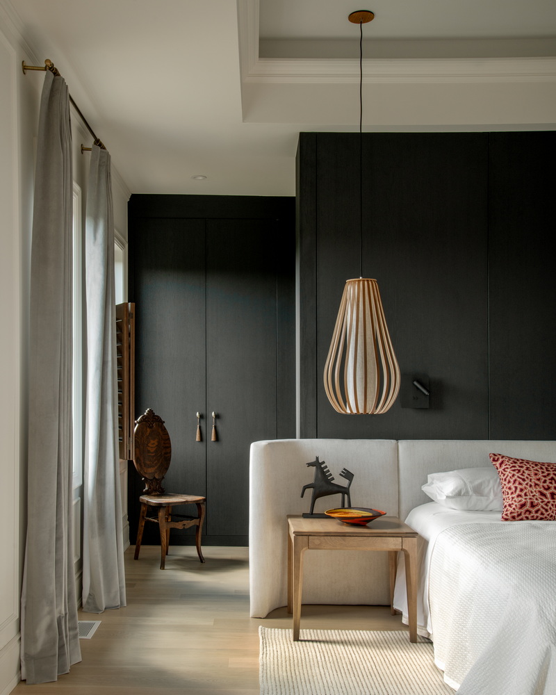 primary bedroom in the 2026 Minto dream home showing part of the bed, curved and upholstered headboard and walk-through closet