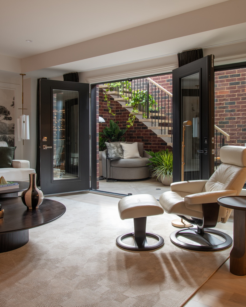 the view of the solarium in the 2026 Minto dream home from the adjacent family room in the basement