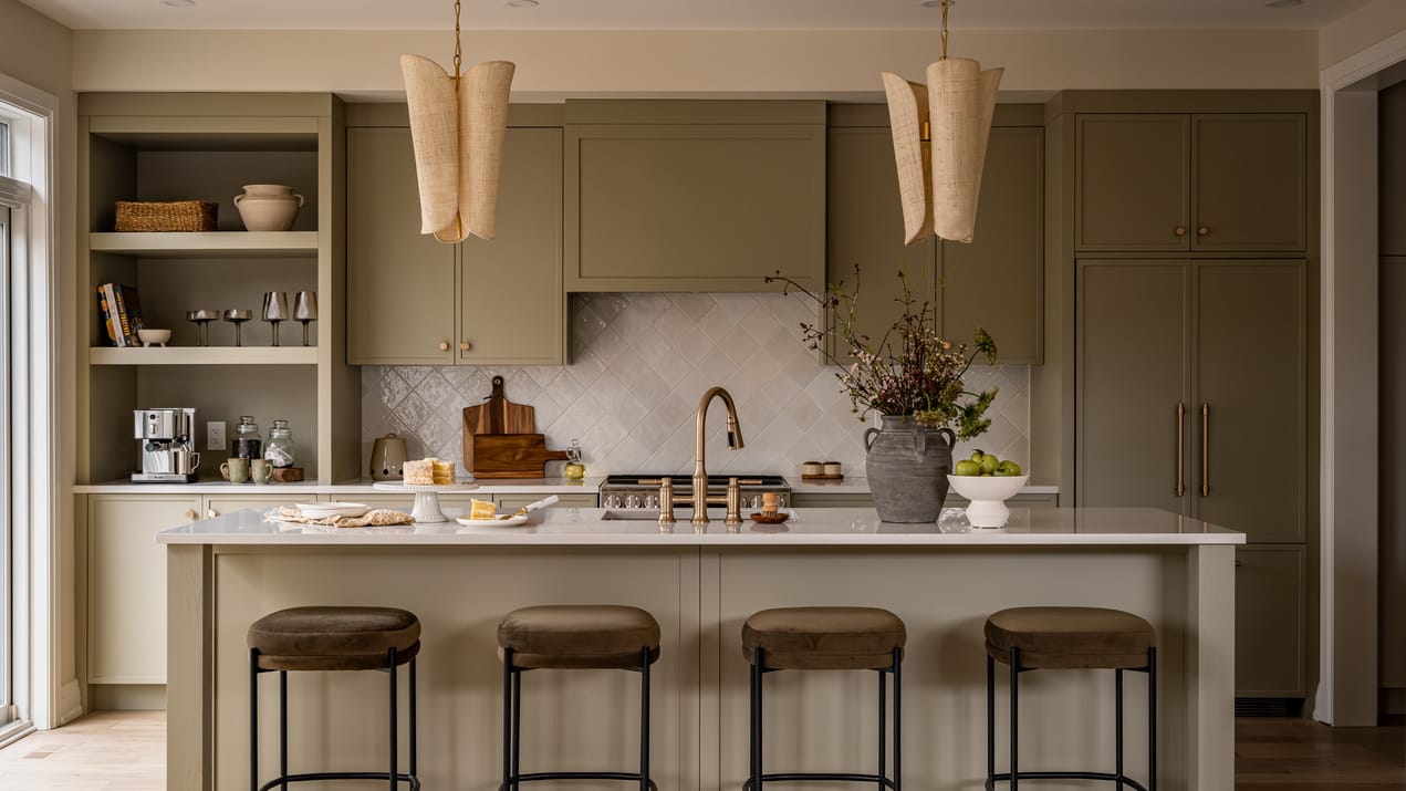 sage kitchen with island and pendant lights