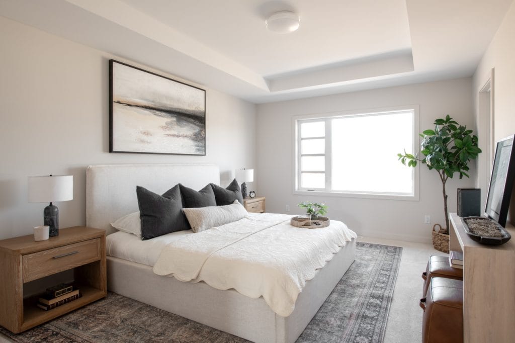 primary bedroom in hn's Weston model at Kanata Lakes done in light neutrals and a tray ceiling