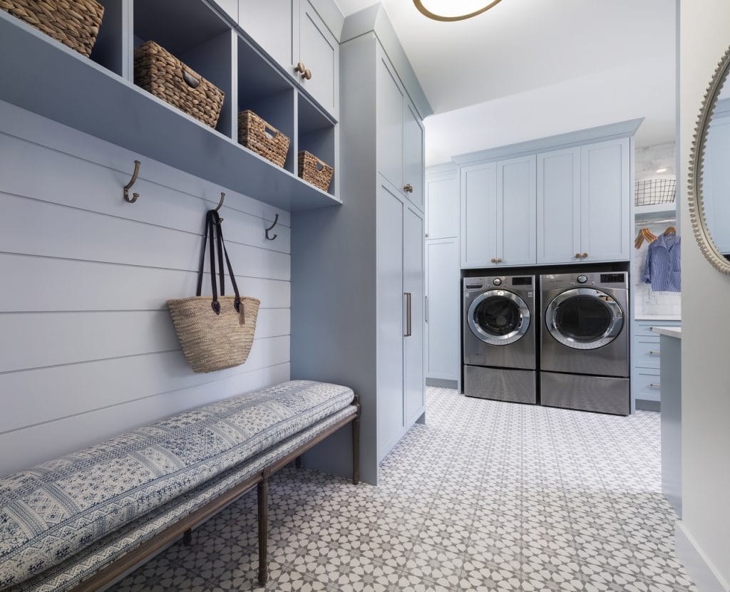 combined murdoom and laundry room with pale blue built-in cabinetry, bench and cubbies