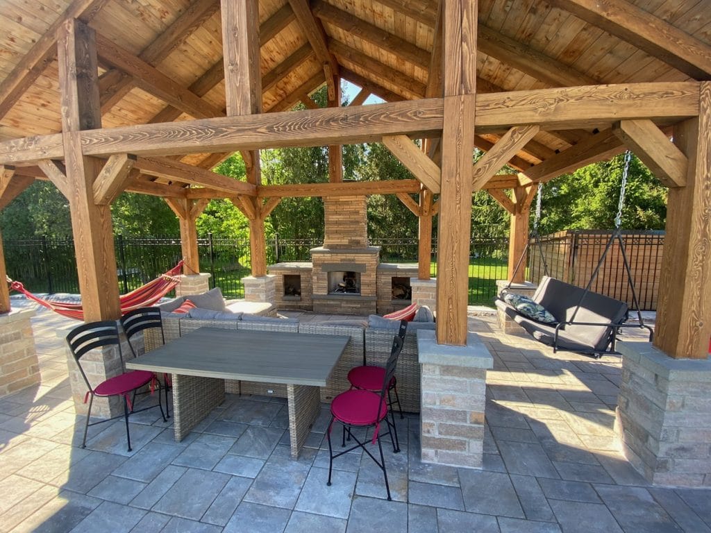 outdoor oasis Aberdeen Development Group covered outdoor kitchen and dining fireplace patio
