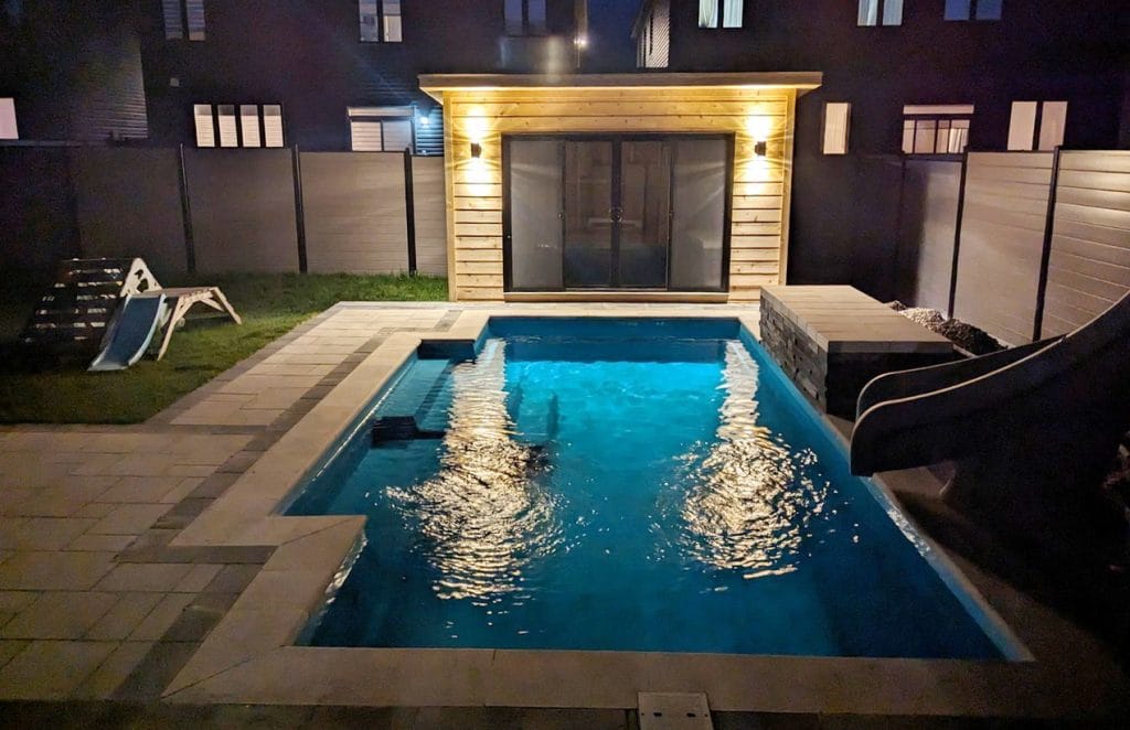 outdoor oasis Aberdeen Development Group backyard pool night lighting 