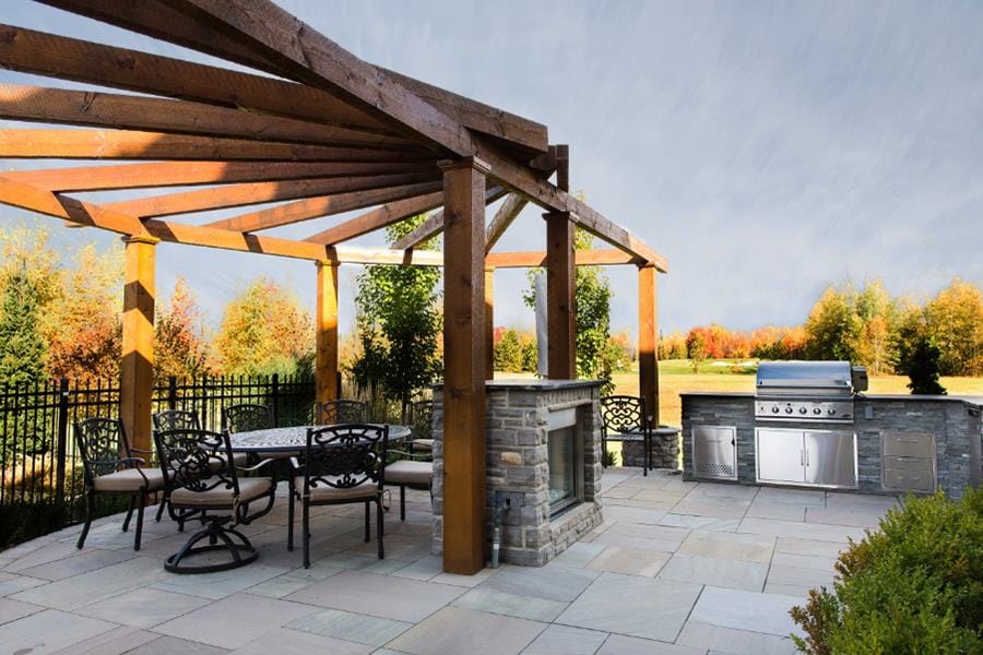 outdoor oasis Artistic Landscape Designs backyard dining kitchen pergola fireplace