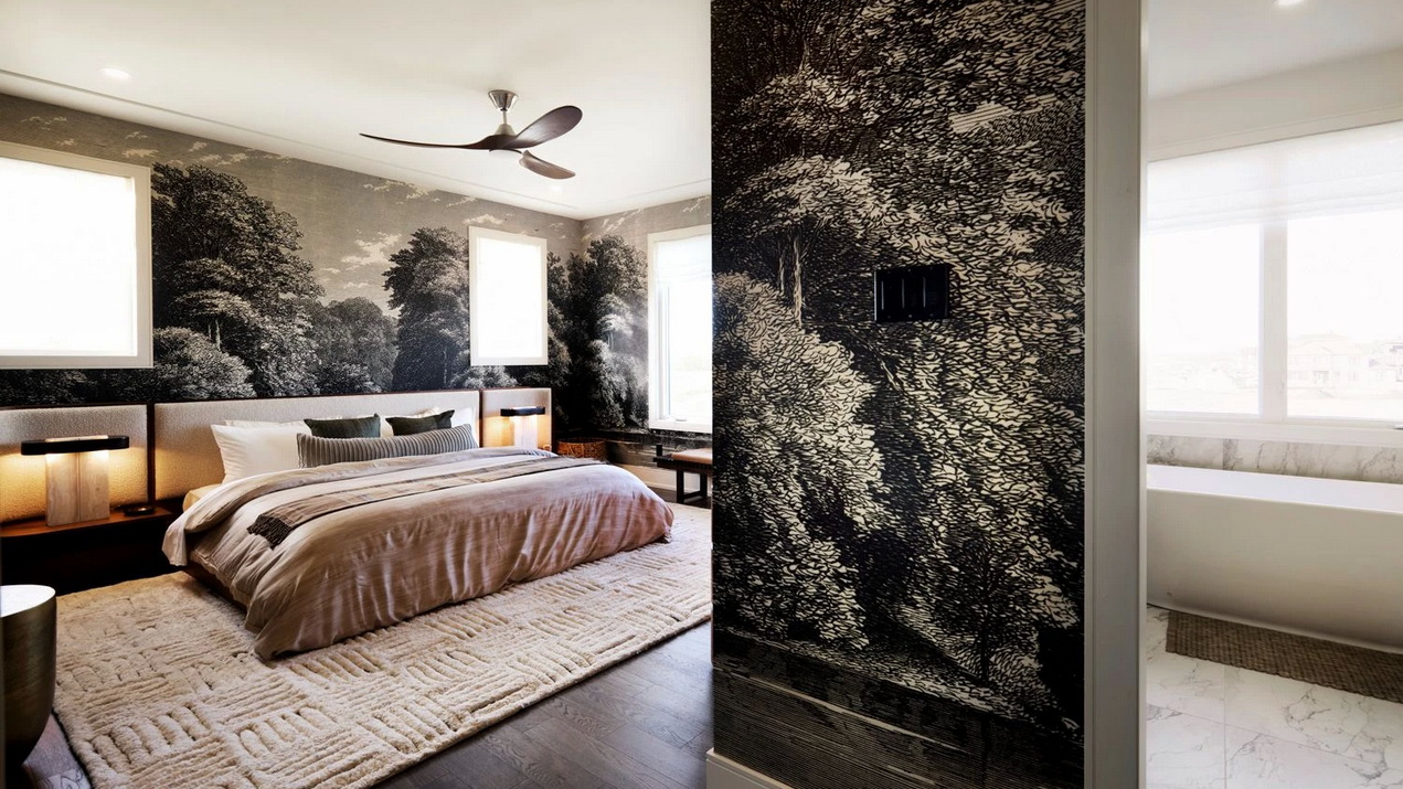 primary bedroom of Caivan’s Stonehaven Loft showing a wraparound wall mural of a forest and the standalone soaker tub in the ensuite