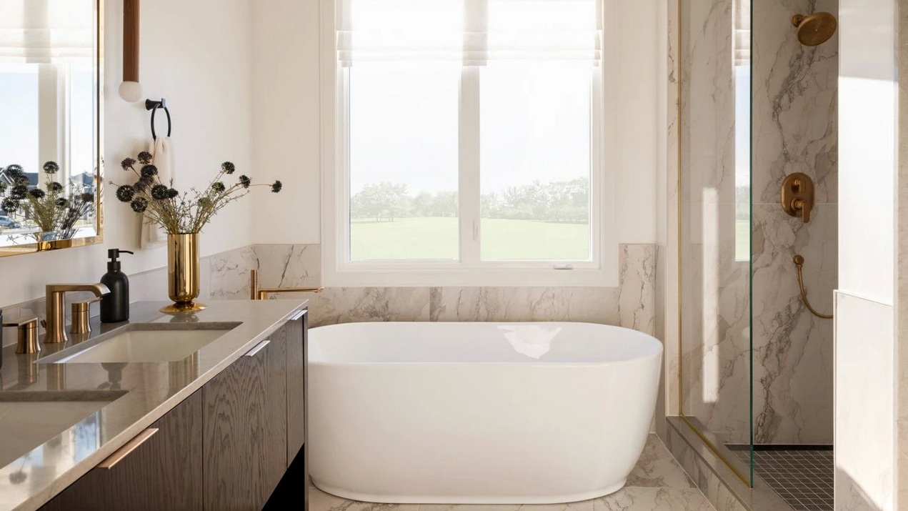 primary ensuite of Caivan’s Stonehaven Loft model home with standalone shower and oval soaker tub