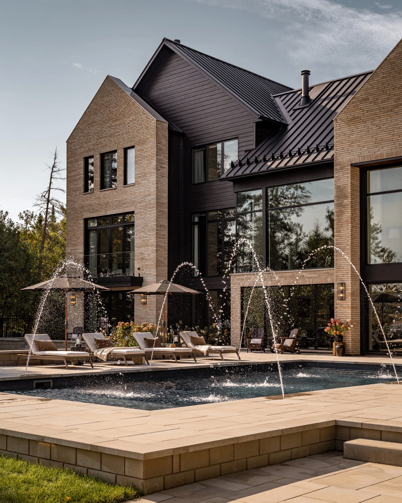 inground pool of a custom home with water jets creating a fountain effect in the pool