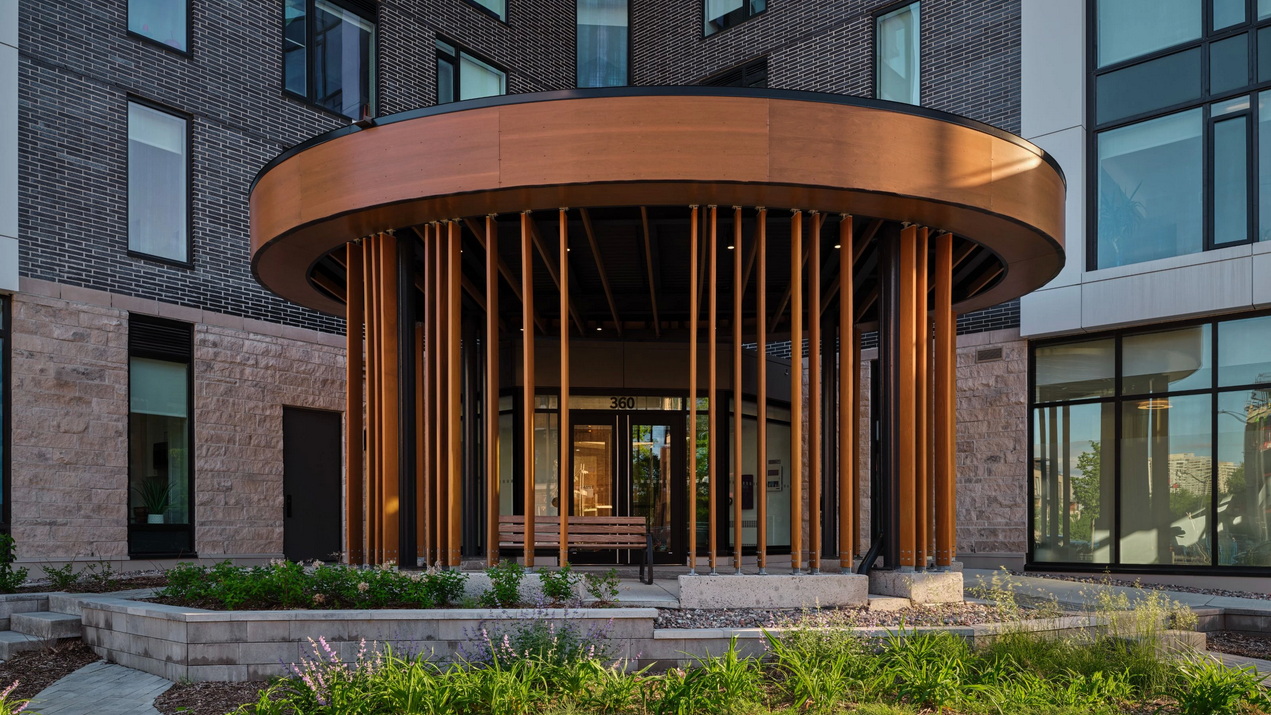 front entrance with elaborate circular wooden portico of eQ’s Spencer condo building