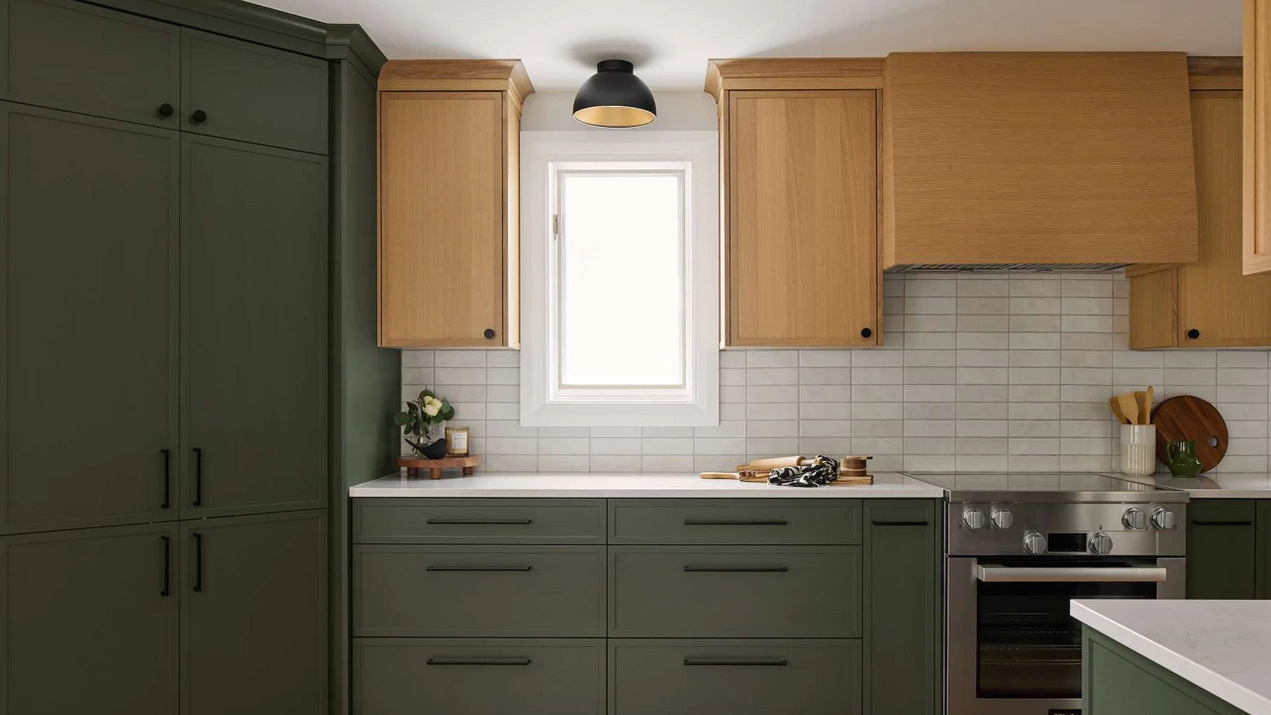 kitchen renovation in a century home with charcoal base cabinets paired with light-stained wood upper cabinets