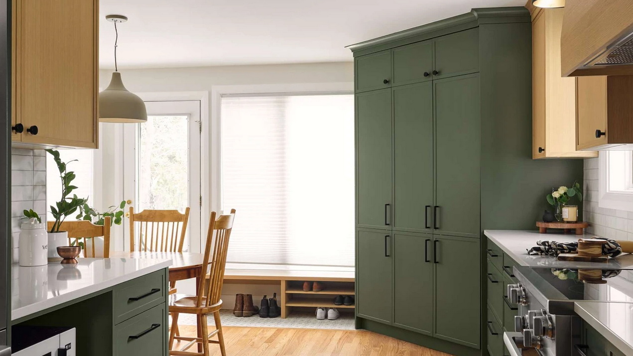 kitchen renovation in a century home with charcoal base cabinets paired with light-stained wood upper cabinets
