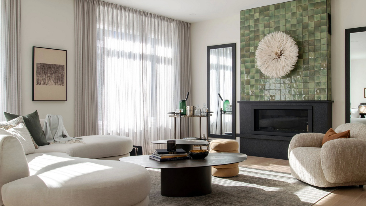 living room of the Esmonde model home with curvy white sectional and fireplace
