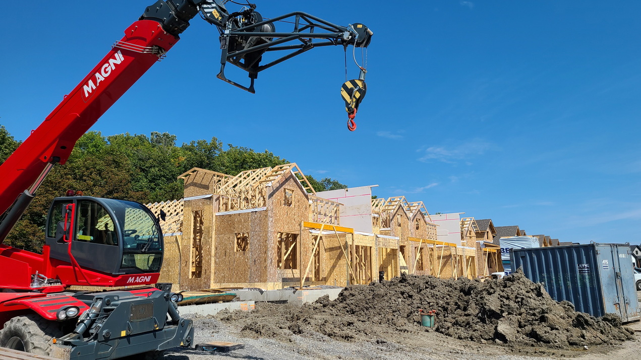 construction site of bungalow towns showing exposed framing and portable crane