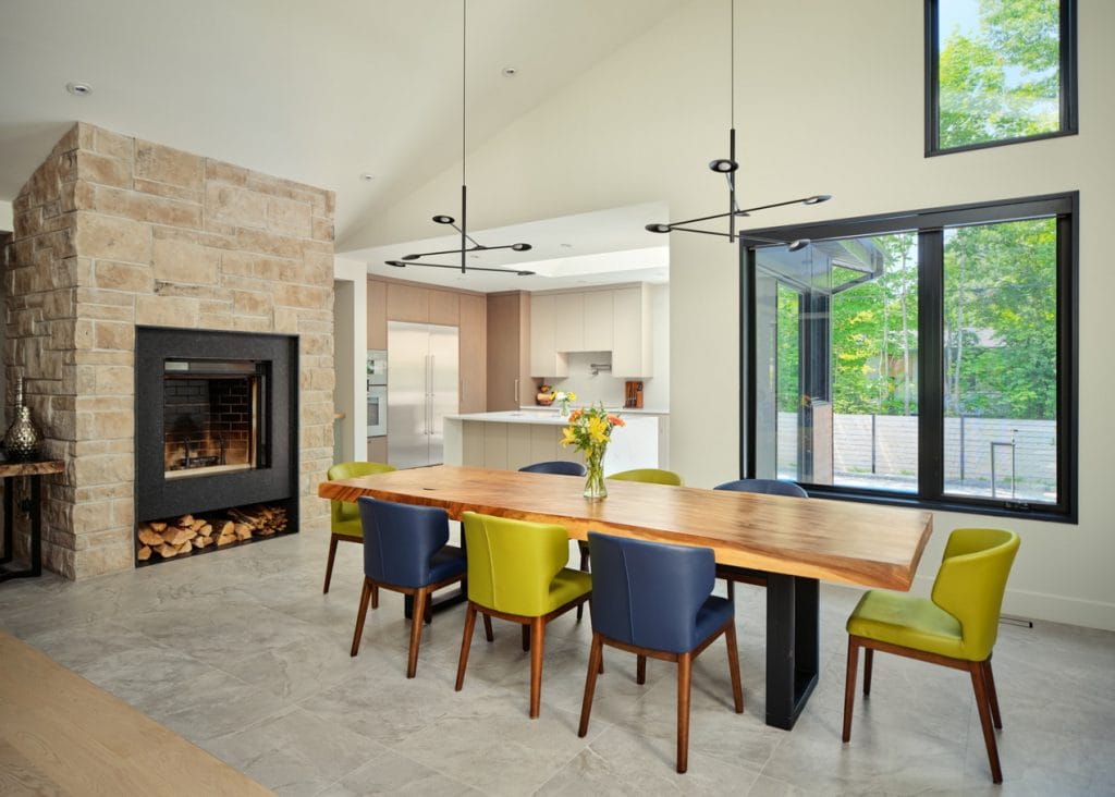 photo of a bungalow dining room with vaulted ceiling and stone fireplace