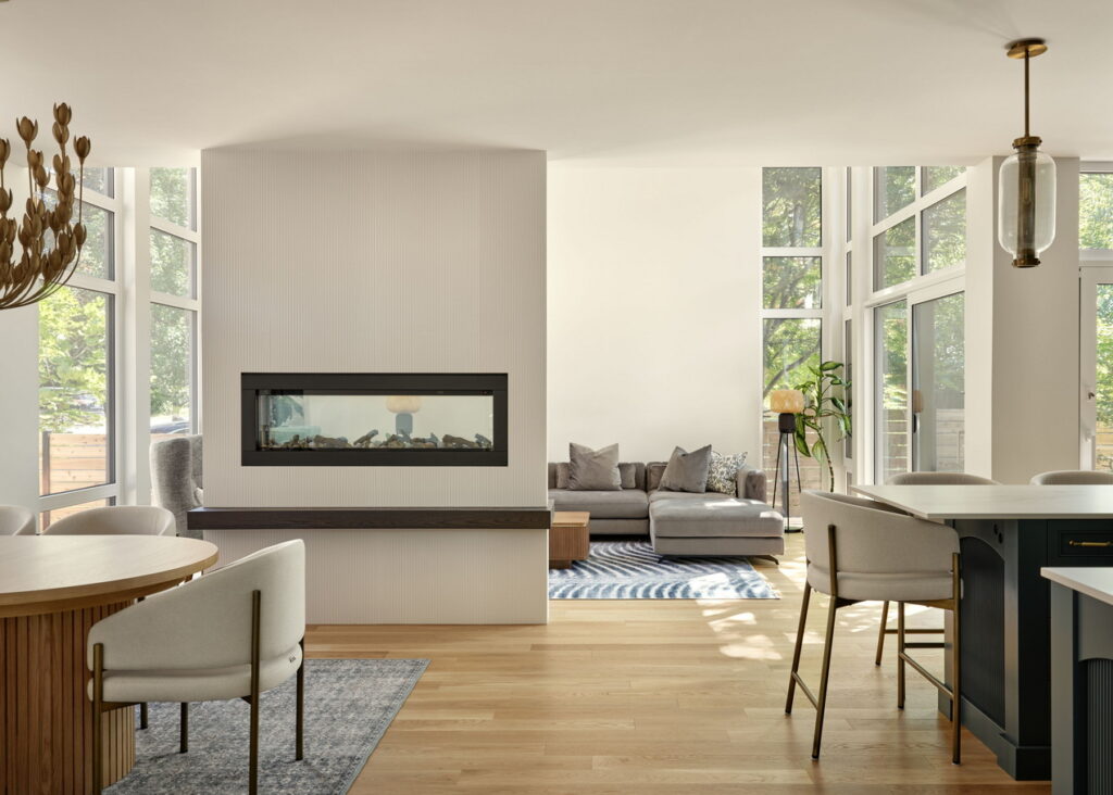 open-concept main floor of a custom home by RND Construction showing a two-sided fireplace