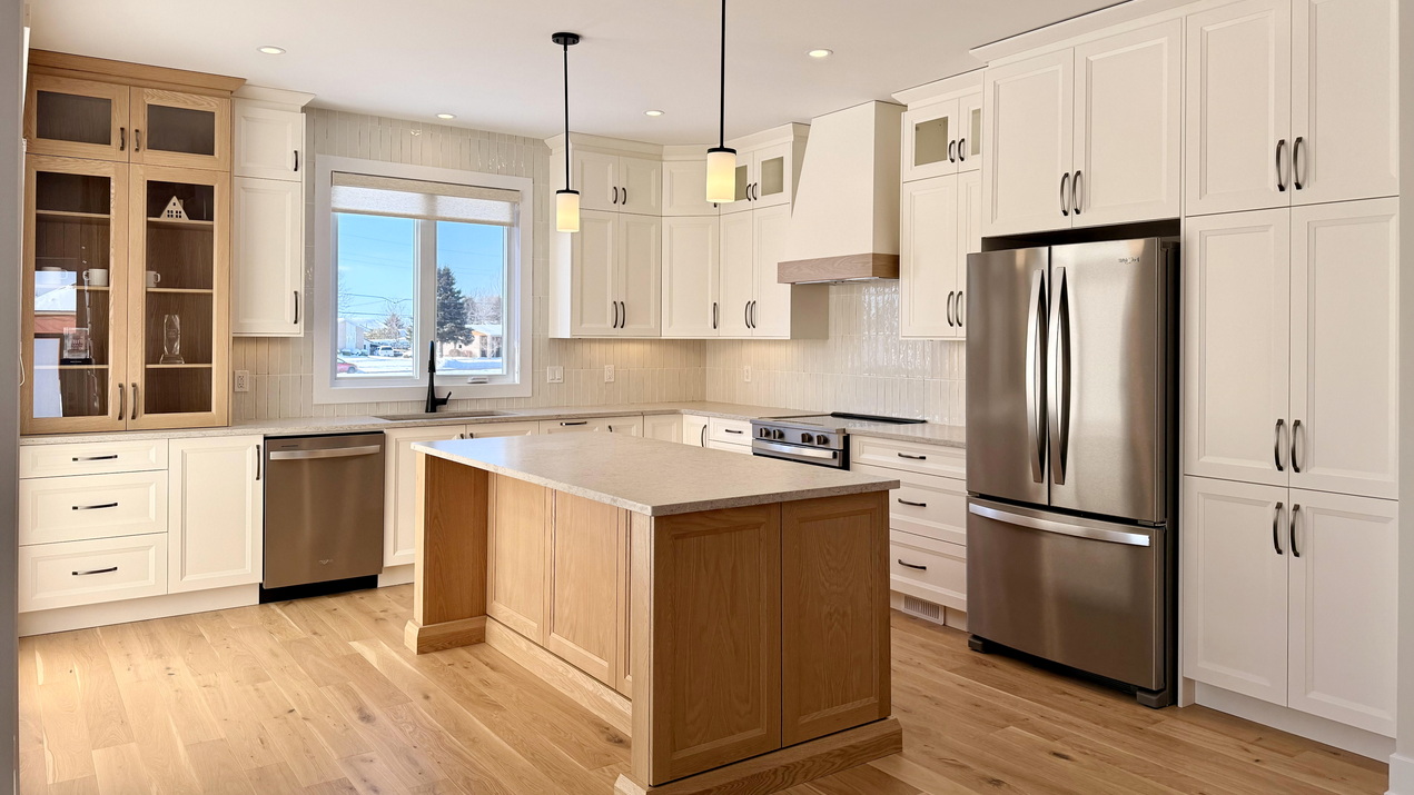 white kitchen with shaker cabinets and a stained wood island