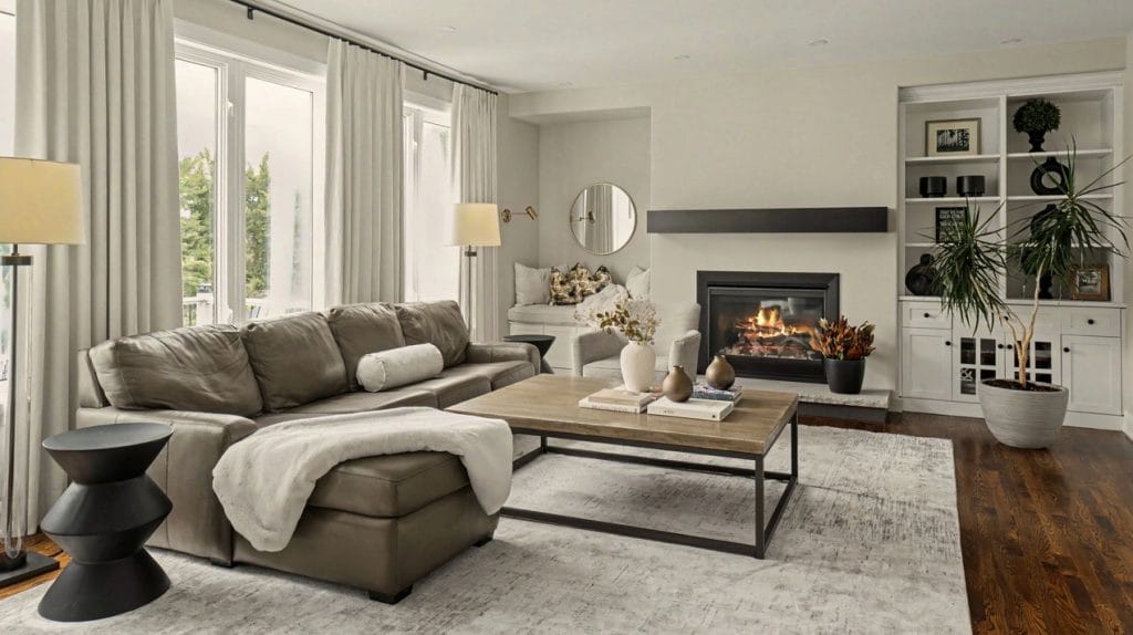living room with sectional couch and fireplace by Amsted Design-Build
