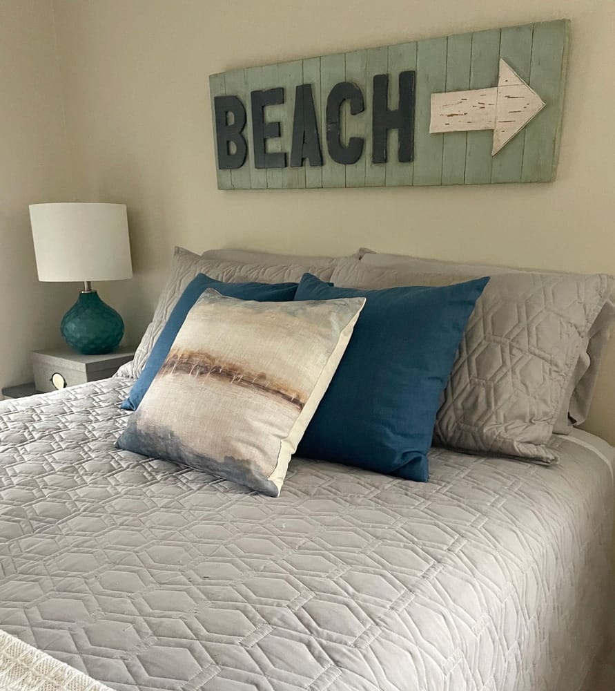beach sign above a bed