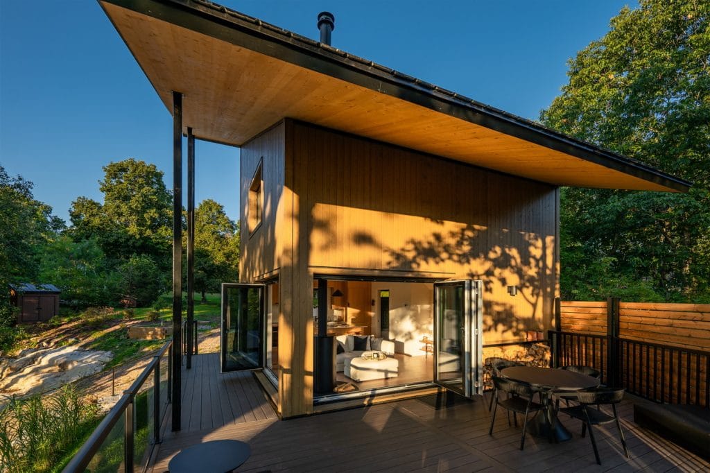 exterior of the CABN show home which has a wraparound porch and slanted roof