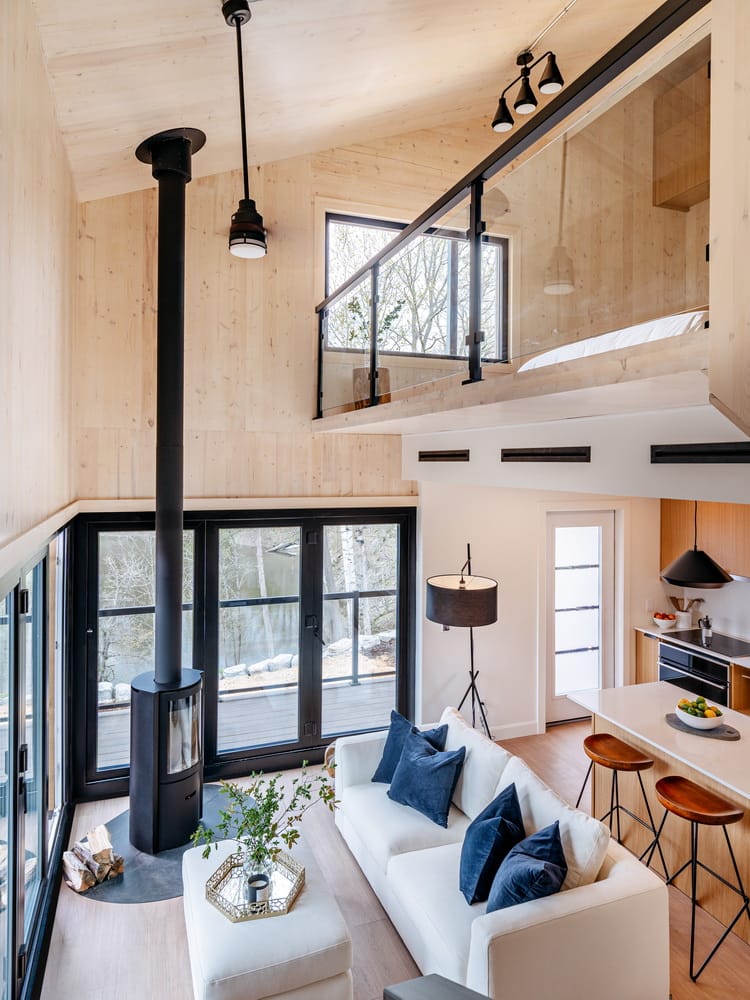 interior of the CABN show home, showing the open-concept main floor and the loft bedroom that overlooks it