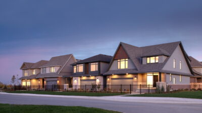 Twilight streetscape photo of Uniform’s single-family home models at Copperwood Estate
