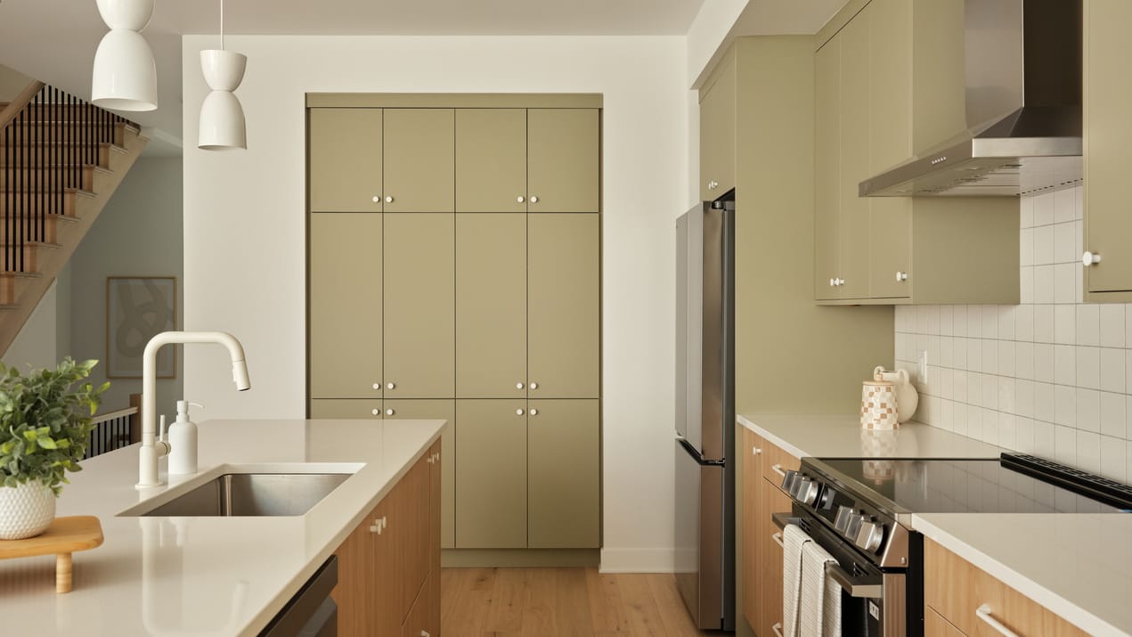 kitchen of the Atlantis townhome model at Kanata Lakes showing the built-in pantry wall