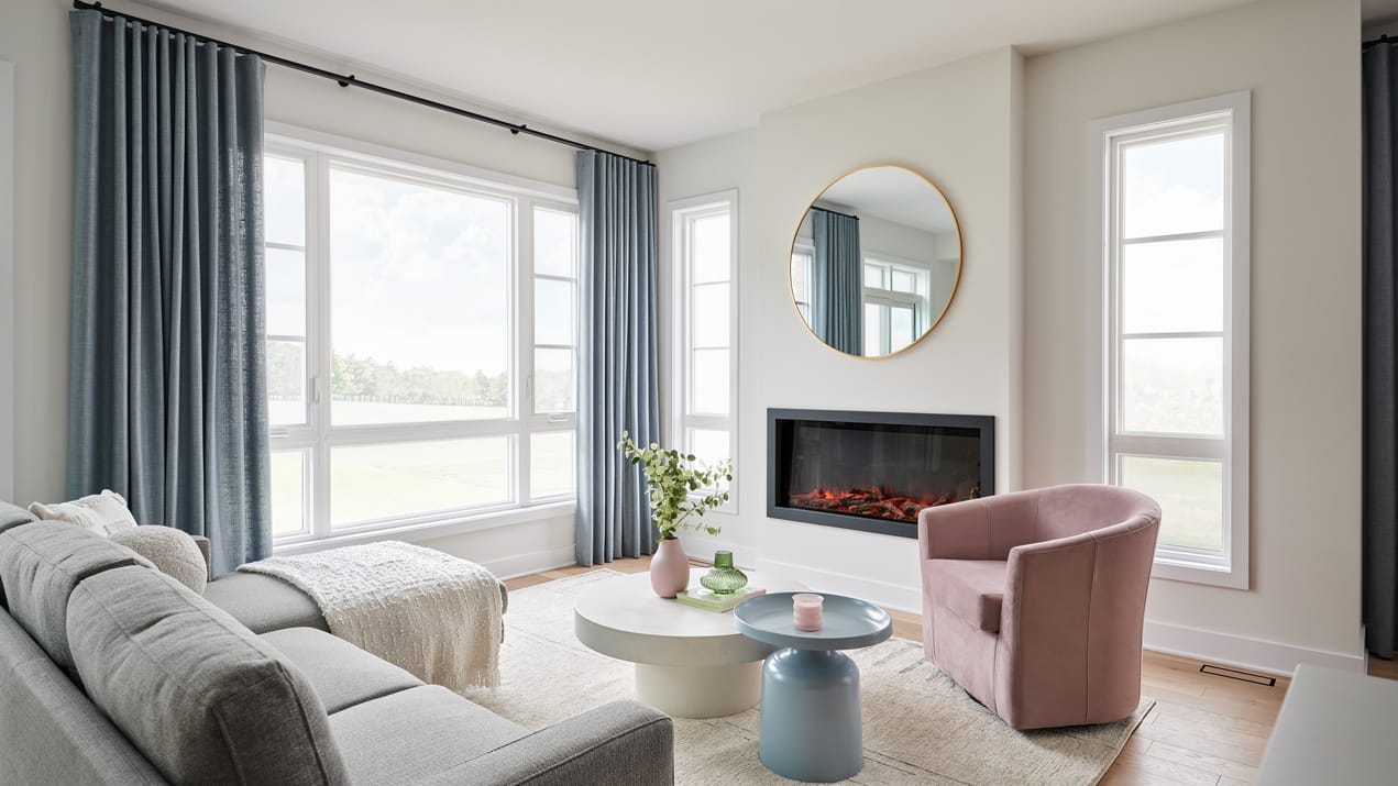 living room of the Santa Maria townhome model at Riverside South with a linear electric fireplace and a coastal vibe
