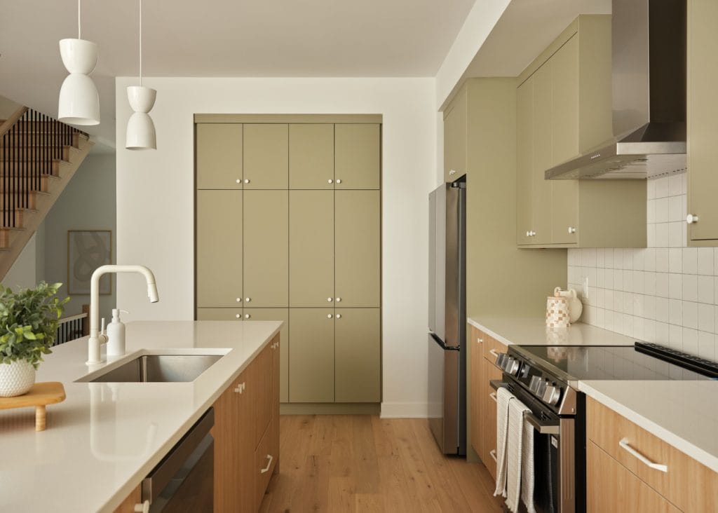 kitchen of the Atlantis townhome model at Kanata Lakes showing the built-in pantry wall