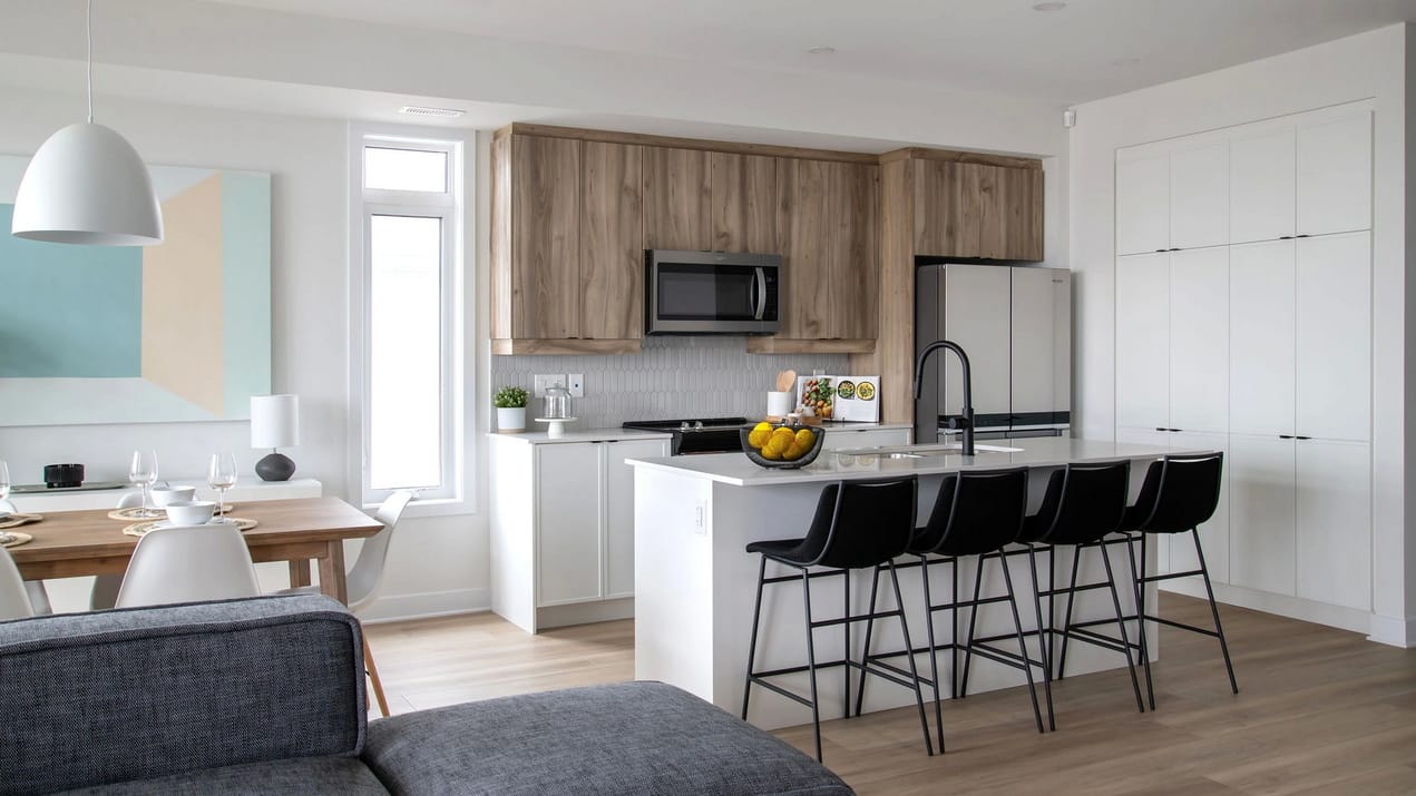 open-concept living room, dining room and kitchen of a condo flat by Urbandale Construction